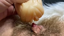 Hairy pussy cums in closeup by big clit inside flashlight